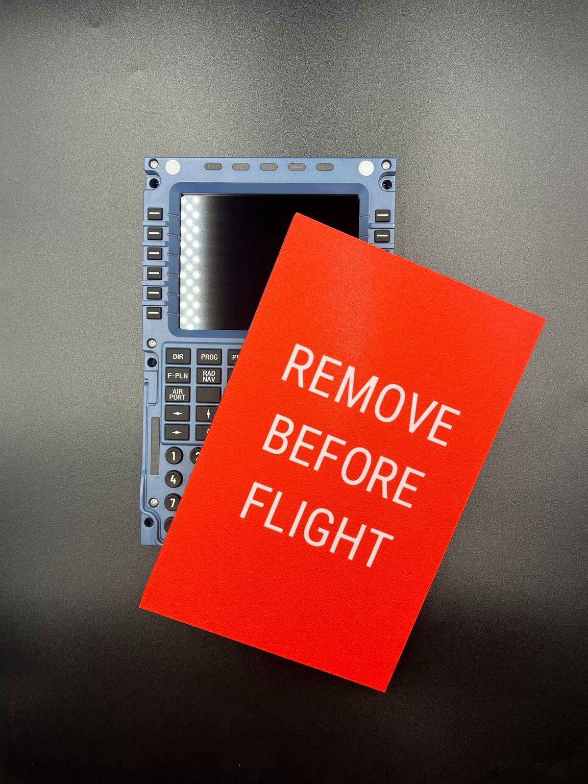 Red Winwing / WINCTRL MCDU dust cover with REMOVE BEFORE FLIGHT lettering